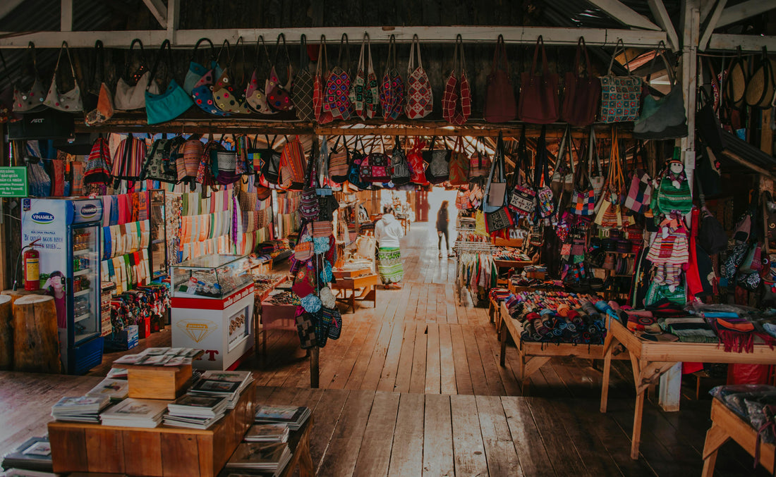 Colorful traditional Indian retail market with handcrafted bags, textiles, and souvenirs displayed in a wooden store, reflecting vibrant local shopping culture.