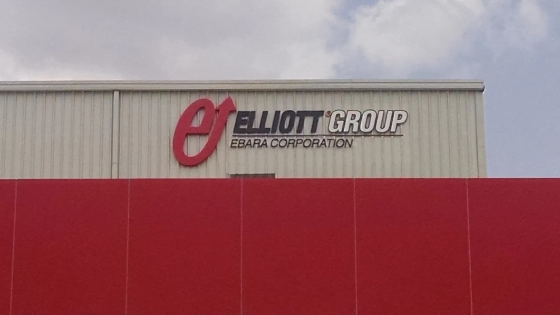 Red Elliott Group letters on the wall of a factory shed