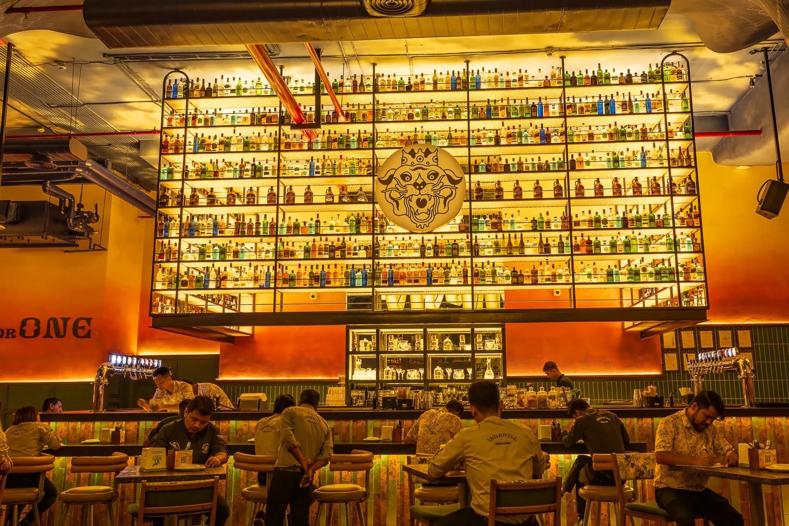 Ironhill bar with a large lit bottle gantry and a round tiger emblem