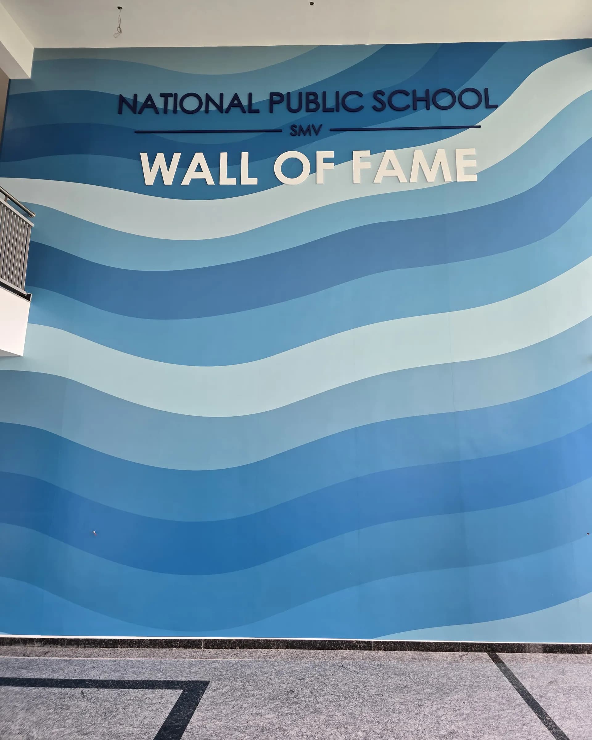National Public School SMV Wall of Fame: a full-wall wave graphic in blues with the school name and Wall of Fame in raised letters