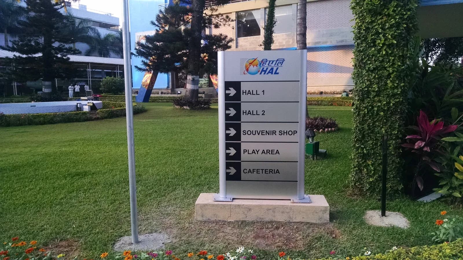 HAL outdoor wayfinding totem with arrows to exhibition halls, souvenir shop, play area and cafeteria