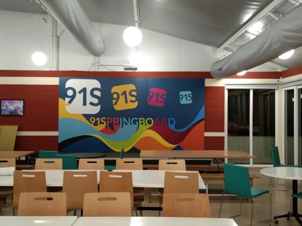91springboard cafeteria wall with a colourful wave mural and the 91S logos