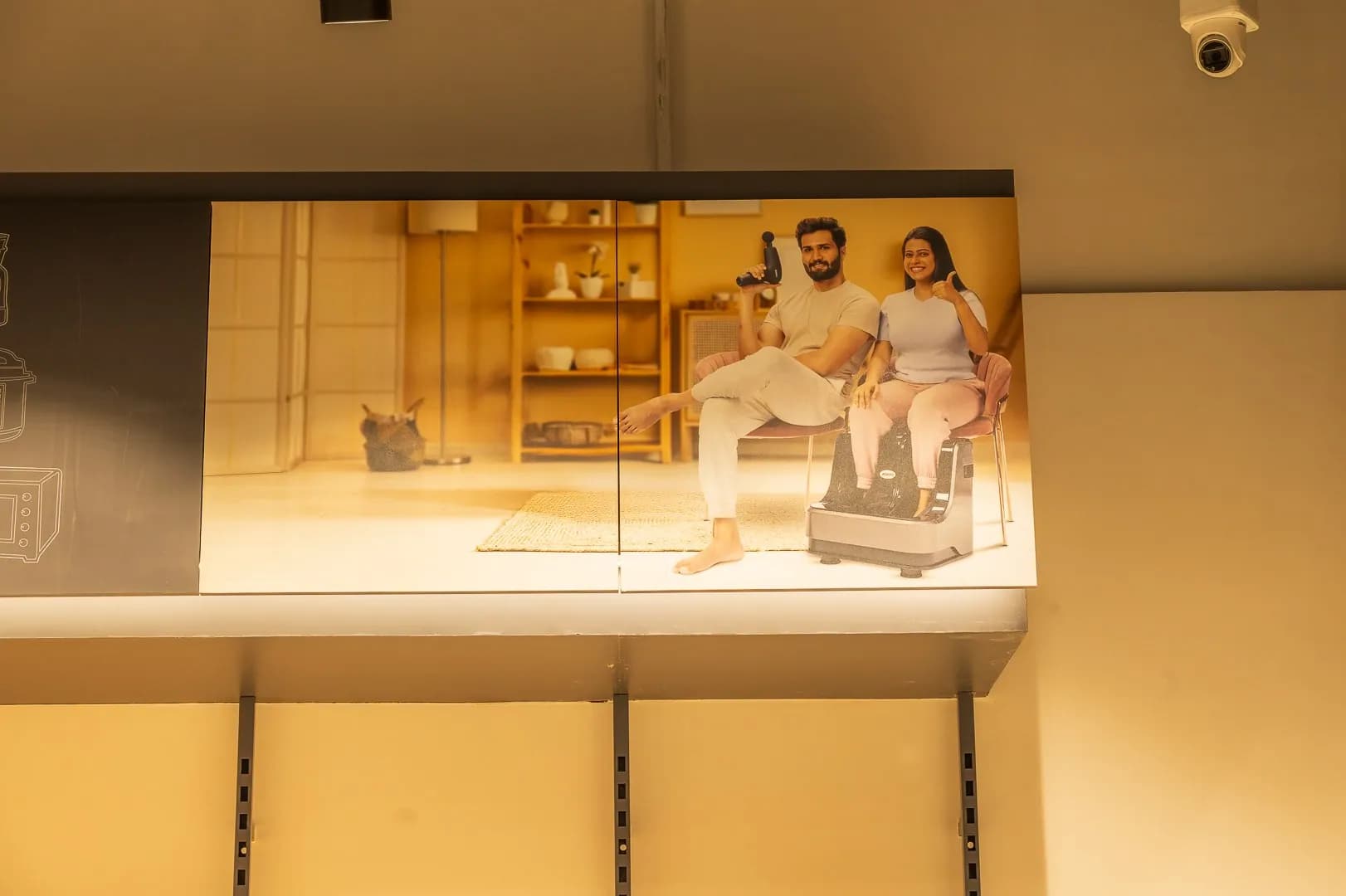 Backlit lifestyle graphic above display shelves at Agaro
