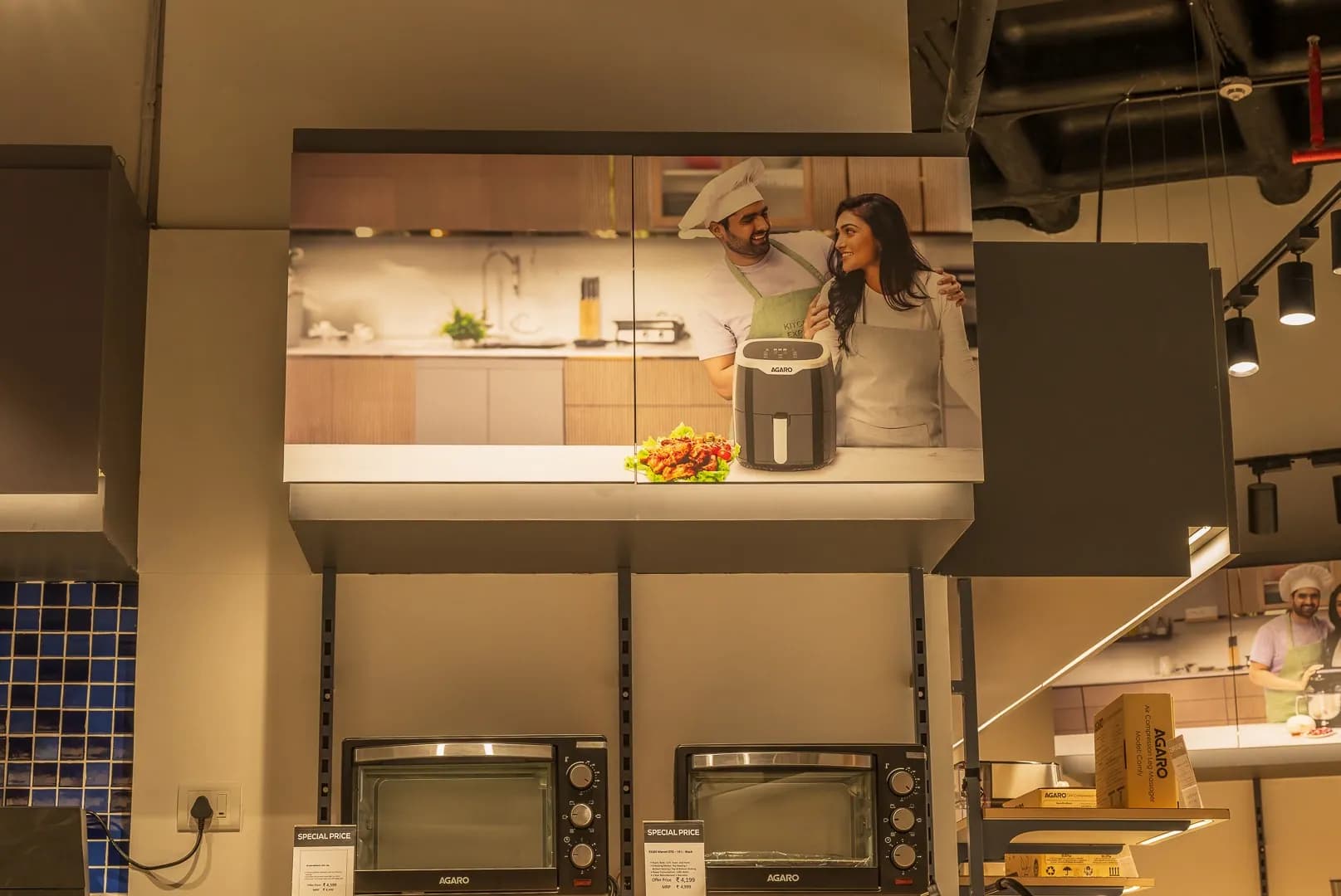 Backlit lifestyle graphic above the oven display at Agaro