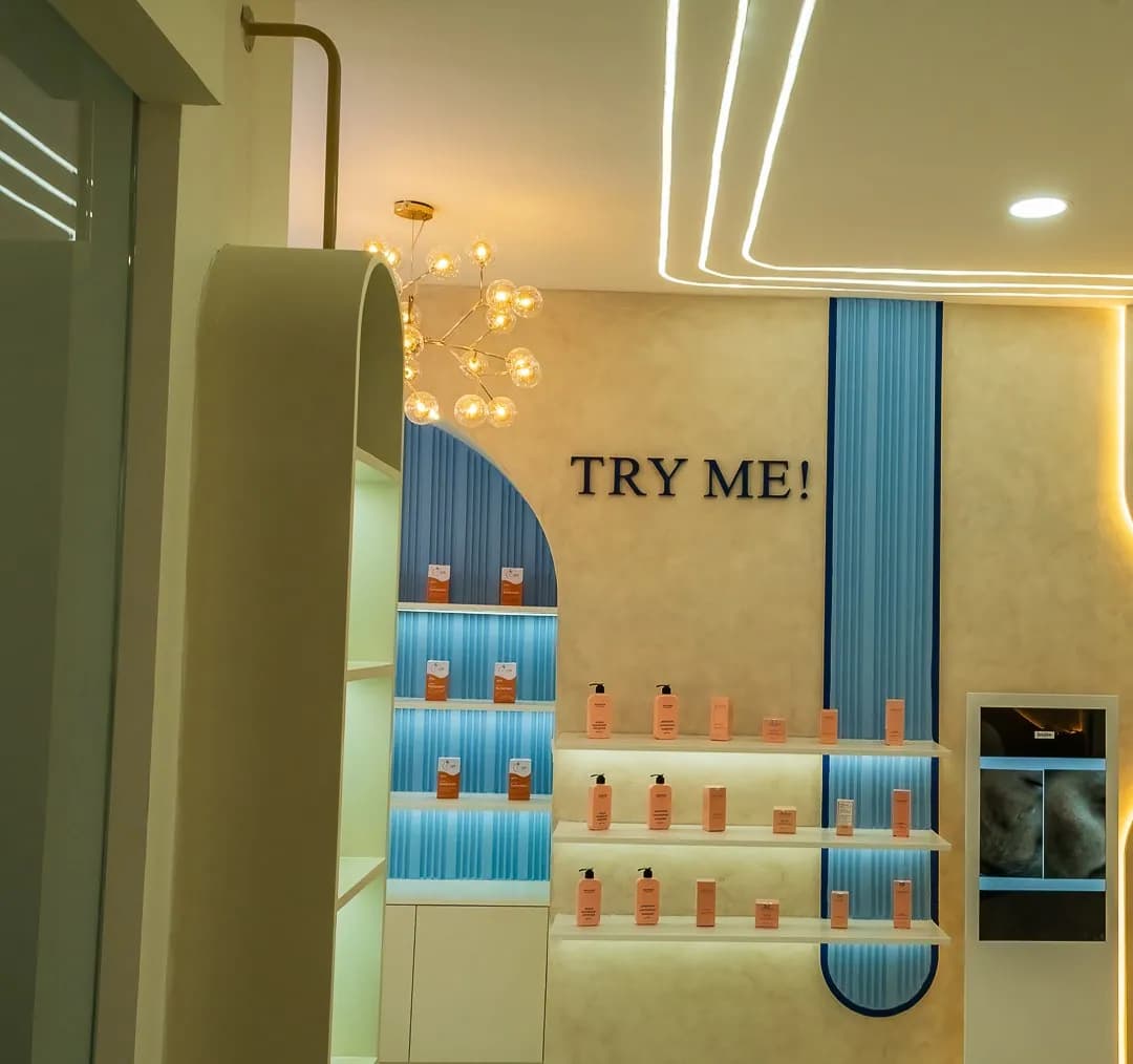 CosMediQ product display niche with a blue fluted panel and Try Me lettering