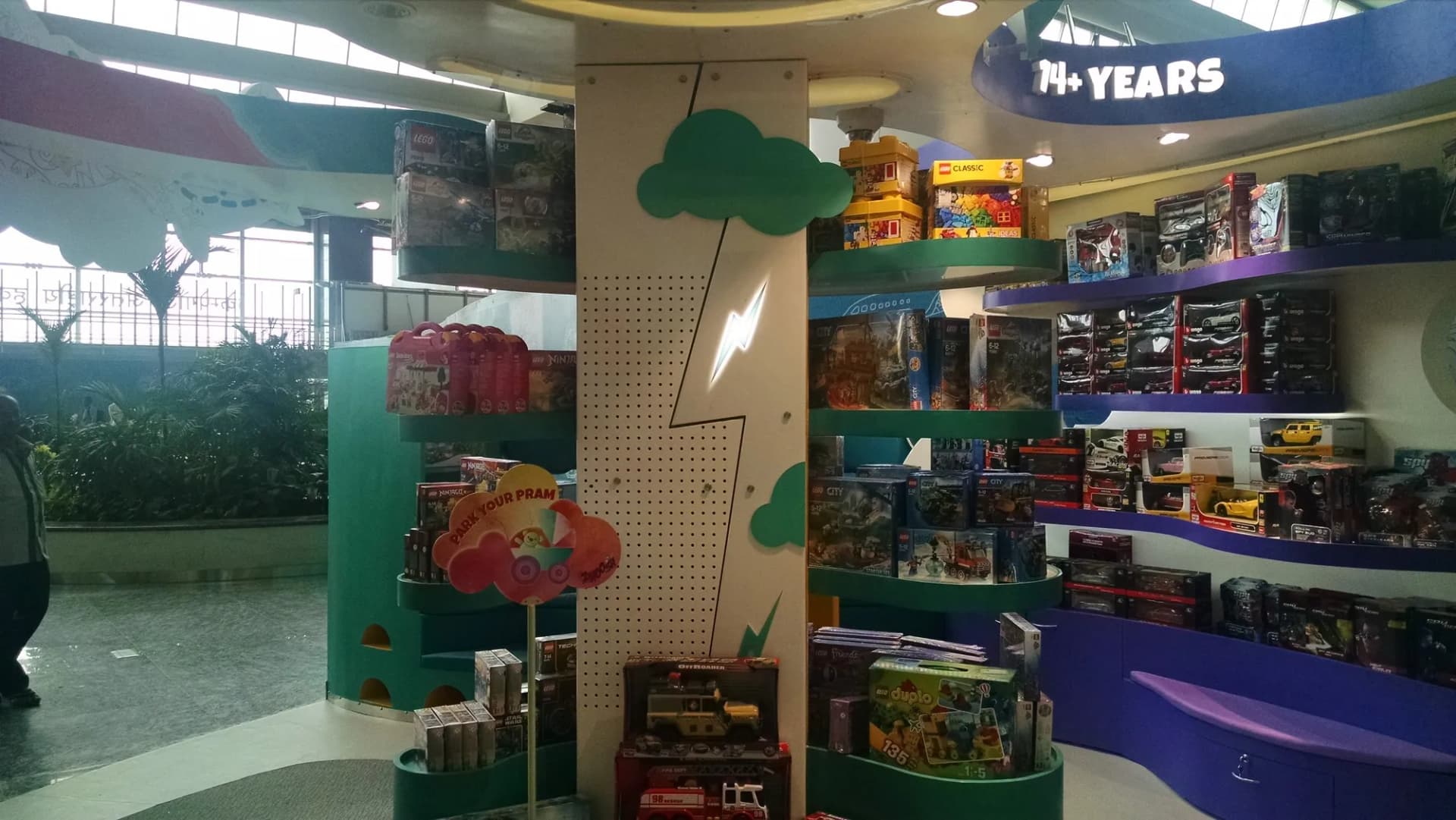 Toy section at Crossword with cloud cut-outs above the shelves