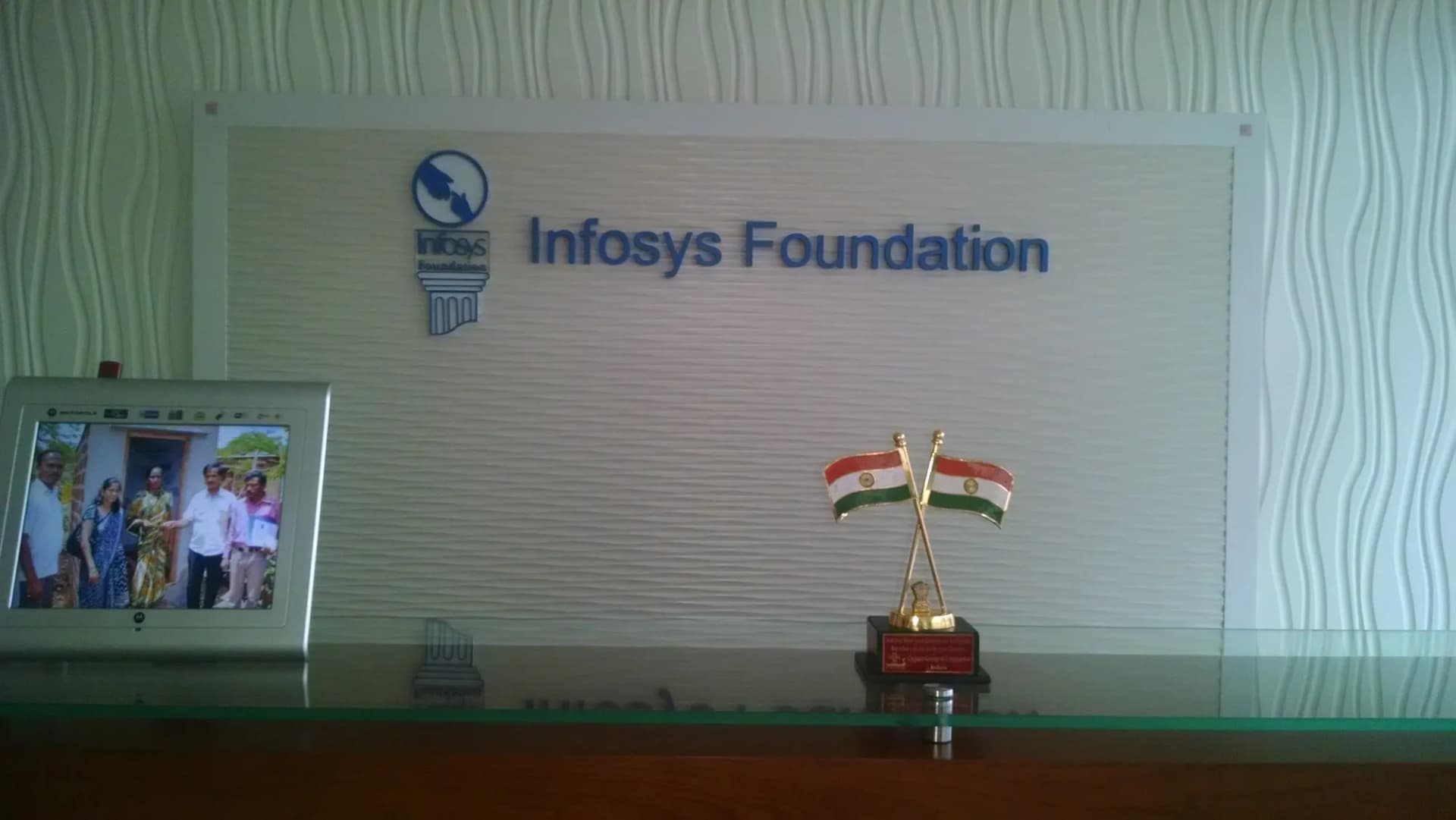 Infosys Foundation logo letters on a textured reception wall