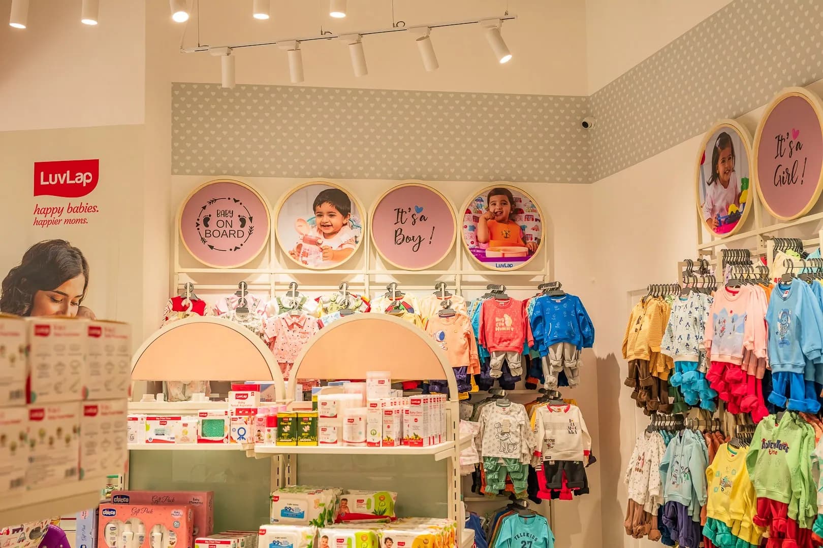 LuvLap store interior with round photo medallions above the clothing displays
