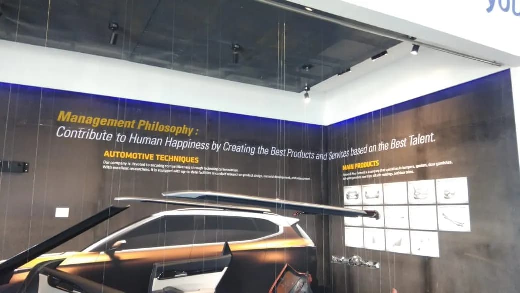 Exhibition display wall for an automotive company with a car graphic and printed text panels