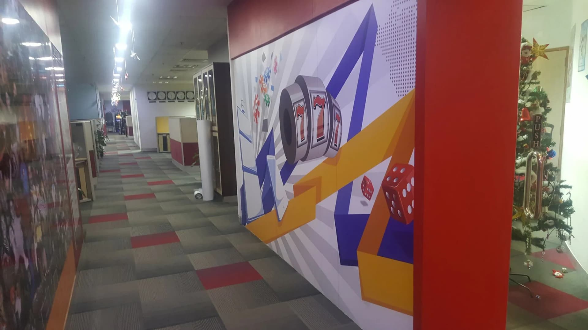 Office corridor at Scientific Games with a large slot-machine and dice wall graphic