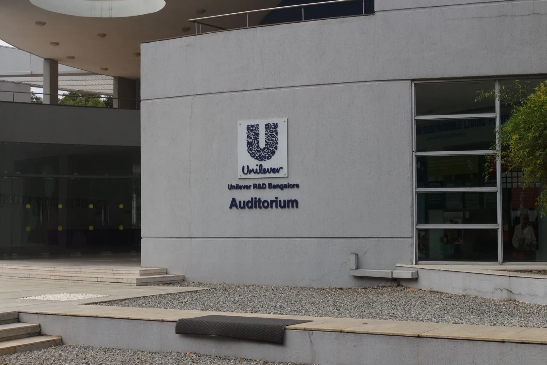Unilever logo and the letters Unilever R&D Bangalore Auditorium on a grey wall
